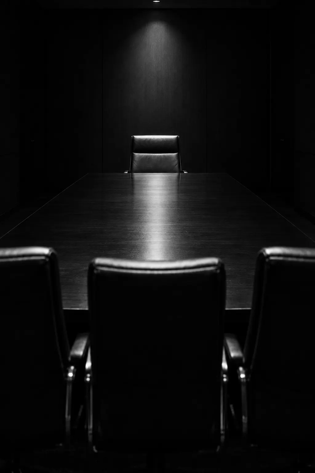 An empty boardroom seen from behind the interview panel